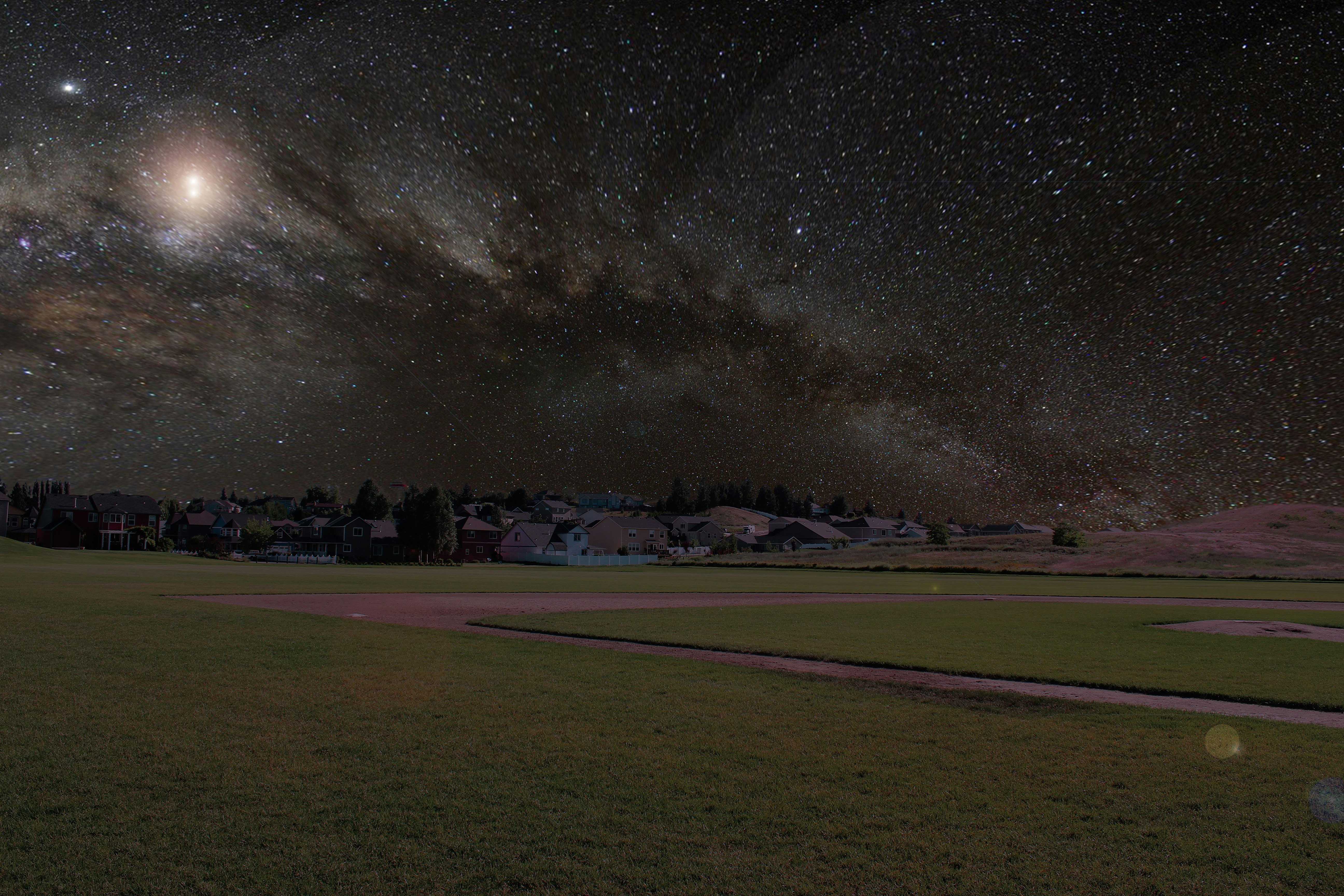 photo of house near field during night time